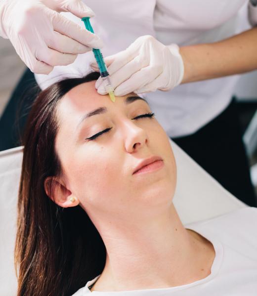 Injectable tissue stimulator on woman face in beauty salon. Aesthetic medicine